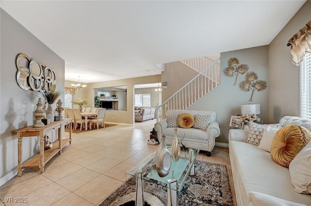 tiled living room featuring an inviting chandelier