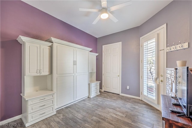 unfurnished bedroom featuring multiple windows, ceiling fan, and light hardwood / wood-style flooring