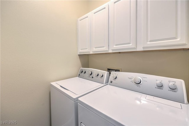 laundry area featuring cabinets and washing machine and clothes dryer