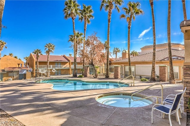 view of pool featuring a hot tub and a patio