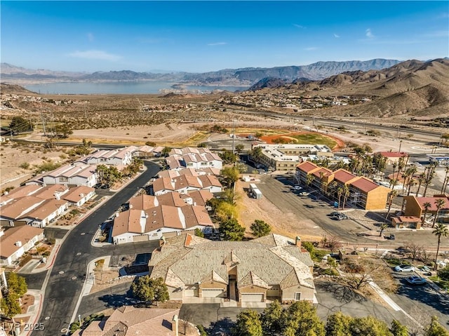 birds eye view of property featuring a water and mountain view