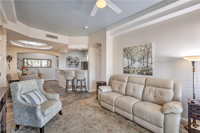 living room featuring hardwood / wood-style flooring and ceiling fan
