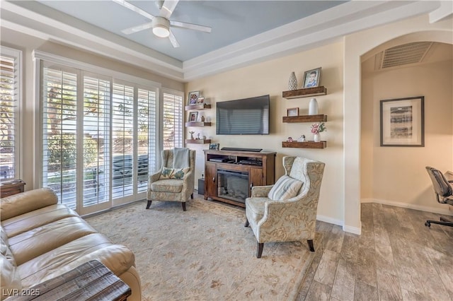 living room featuring ceiling fan and light wood-type flooring