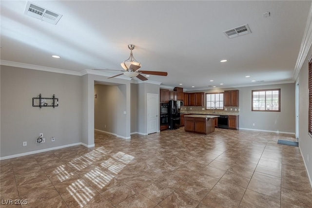 unfurnished living room with ornamental molding, tile patterned floors, and ceiling fan