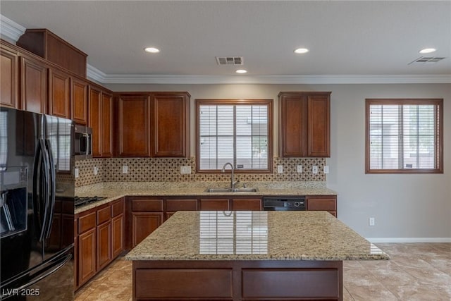 kitchen with plenty of natural light, a center island, sink, and black appliances