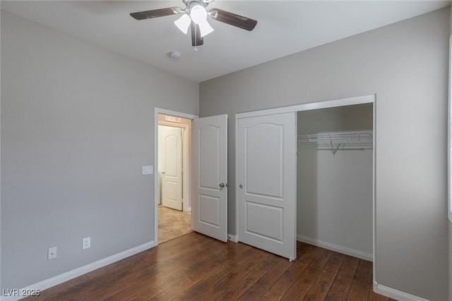 unfurnished bedroom with a closet, dark hardwood / wood-style floors, and ceiling fan