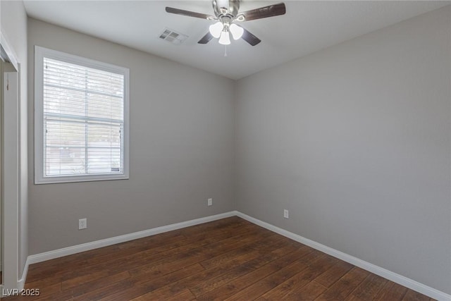 spare room featuring dark wood-type flooring and ceiling fan