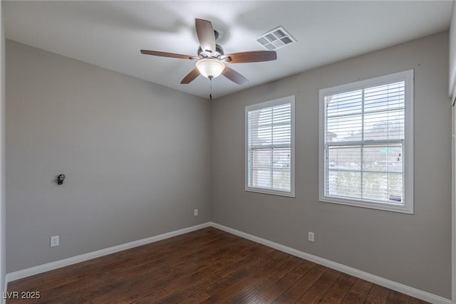 unfurnished room with dark hardwood / wood-style floors and ceiling fan