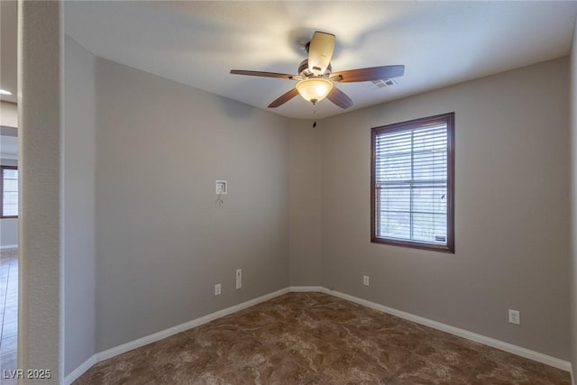 spare room with a wealth of natural light and ceiling fan