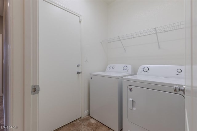 washroom with washing machine and clothes dryer