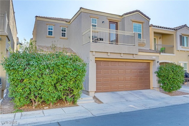 view of property featuring a garage and a balcony