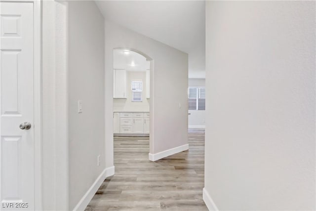 hallway with light hardwood / wood-style flooring