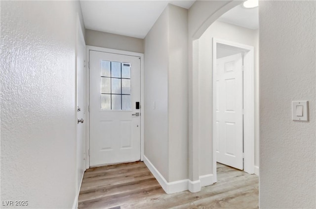 doorway with light wood-type flooring