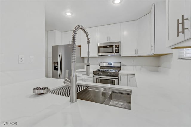 kitchen featuring white cabinetry and stainless steel appliances