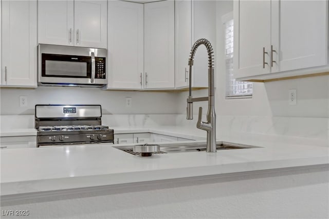 kitchen with stainless steel appliances and white cabinetry