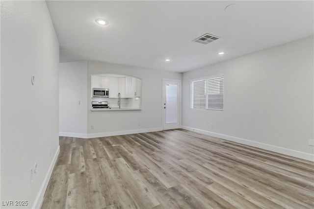 unfurnished living room featuring light hardwood / wood-style flooring