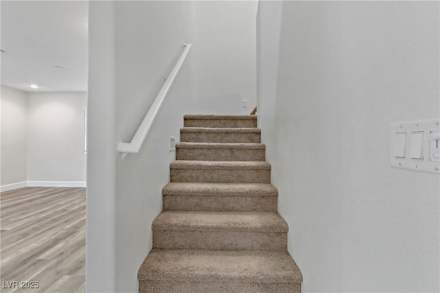 stairs featuring hardwood / wood-style flooring