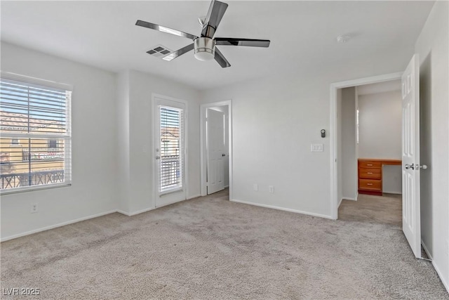 unfurnished bedroom with ceiling fan and light carpet