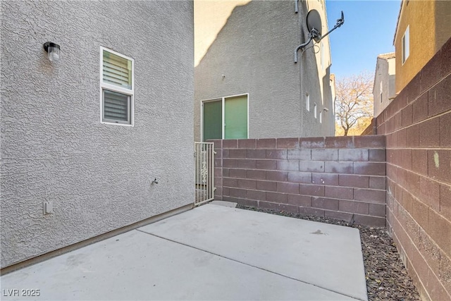 view of side of home featuring a patio area