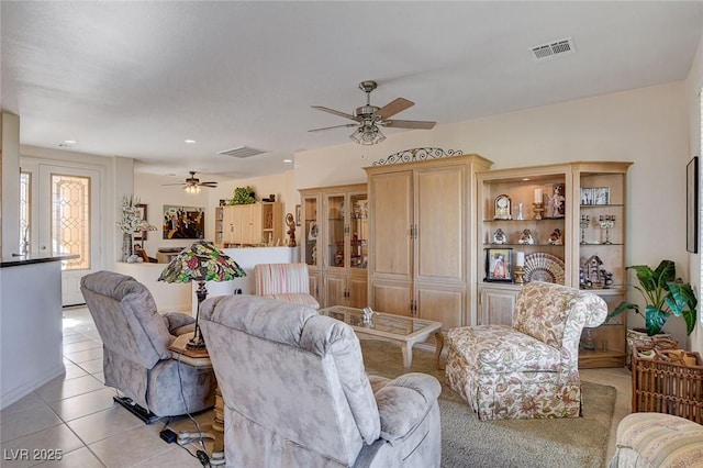 tiled living room with ceiling fan