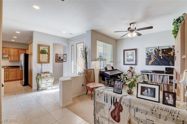 interior space featuring light tile patterned floors and ceiling fan