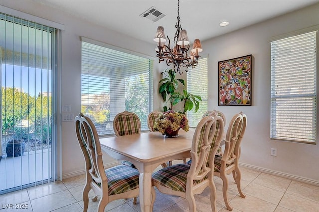 dining room with a notable chandelier and light tile patterned flooring