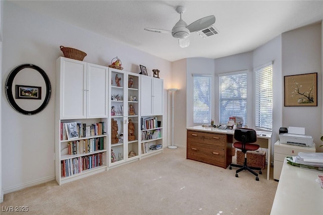 carpeted office featuring ceiling fan