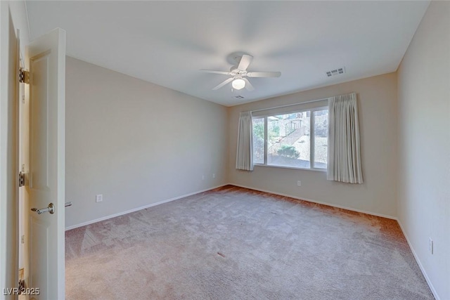 unfurnished room with carpet floors, visible vents, ceiling fan, and baseboards