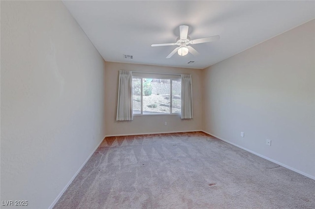 unfurnished room with baseboards, visible vents, ceiling fan, and carpet flooring