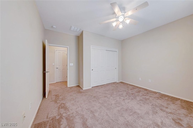 unfurnished bedroom featuring light carpet, baseboards, visible vents, ceiling fan, and a closet