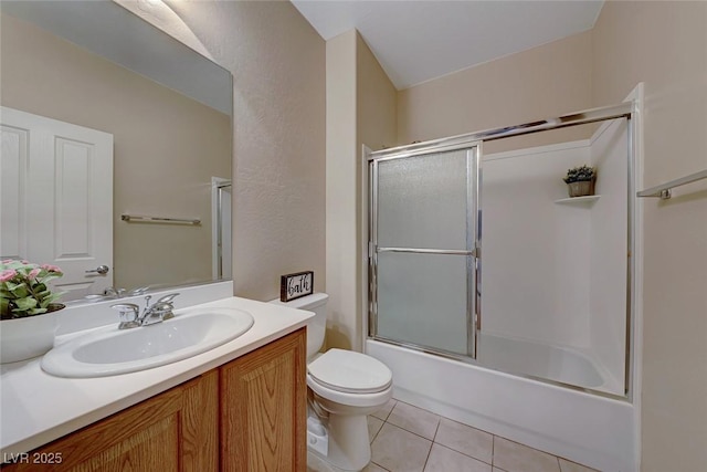 full bathroom featuring enclosed tub / shower combo, vanity, toilet, and tile patterned floors