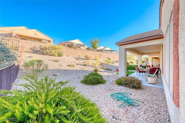 view of yard featuring a patio and a fenced backyard