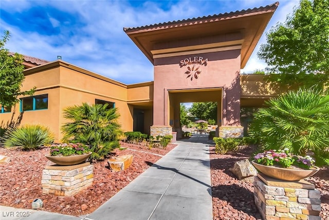 entrance to property with stucco siding