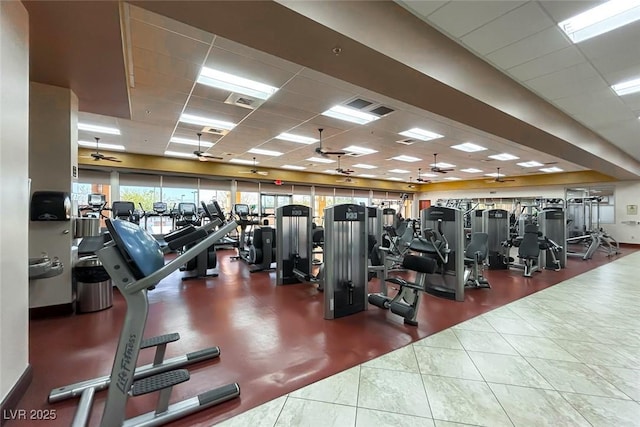 gym featuring tile patterned flooring, a drop ceiling, ceiling fan, and visible vents