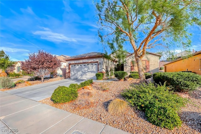 view of front of house featuring driveway, a garage, and stucco siding