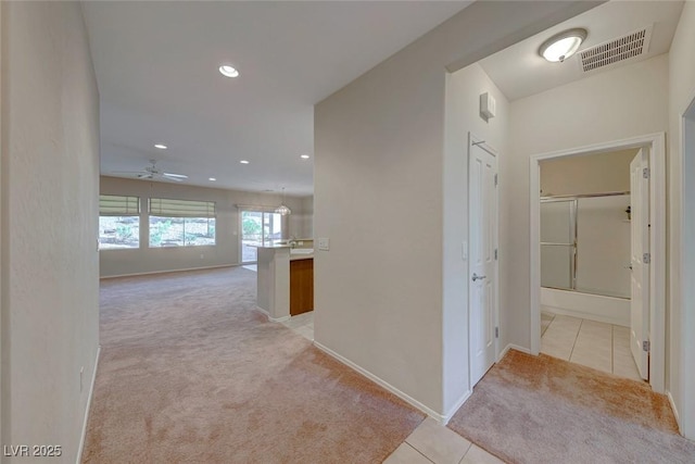 hall featuring light tile patterned floors, recessed lighting, visible vents, light carpet, and baseboards