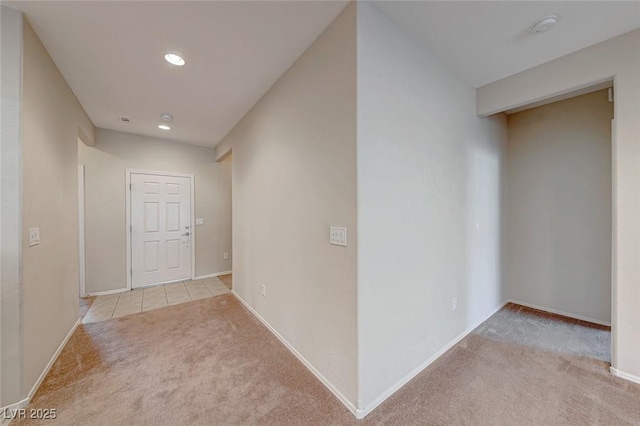 corridor with carpet and baseboards