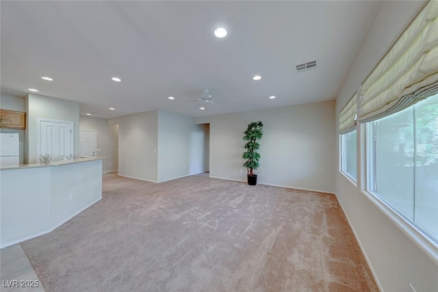 spare room featuring light colored carpet, recessed lighting, visible vents, and ceiling fan