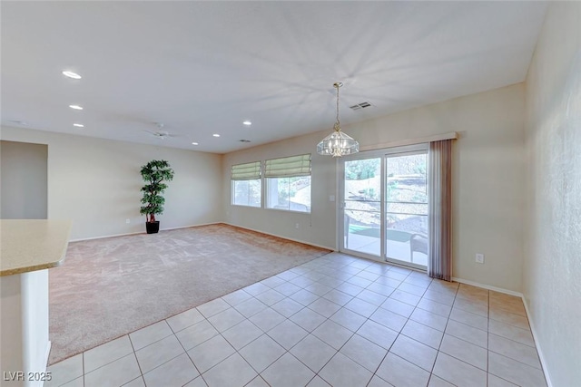 unfurnished room with light tile patterned flooring, recessed lighting, visible vents, and light colored carpet