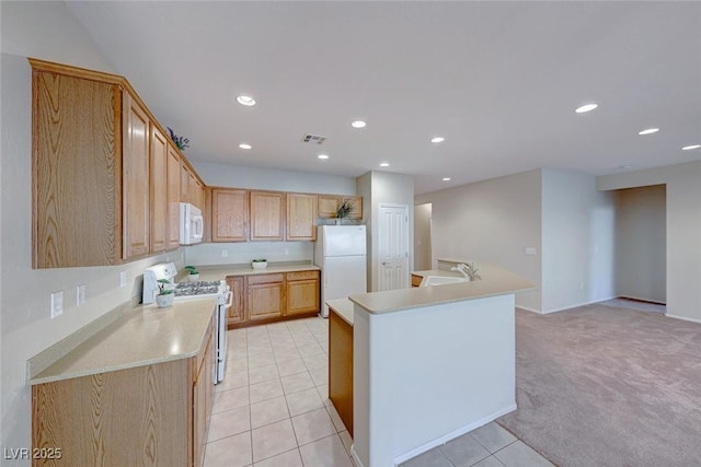 kitchen featuring white appliances, visible vents, light countertops, a sink, and light tile patterned flooring