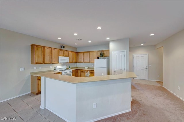 kitchen featuring light tile patterned floors, recessed lighting, white appliances, light countertops, and a large island with sink