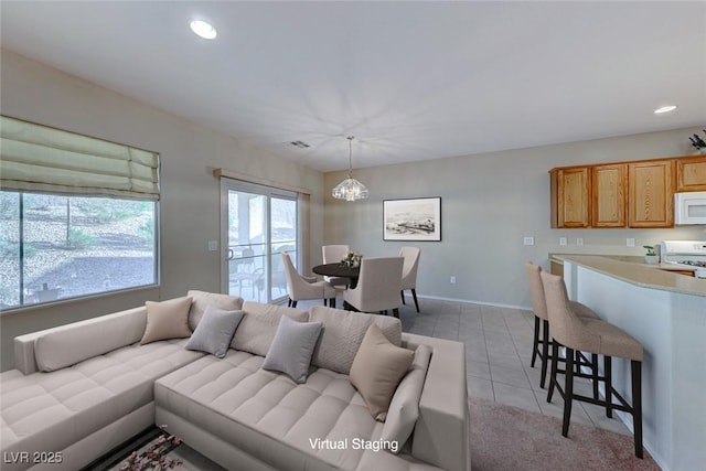 living room featuring recessed lighting, a notable chandelier, baseboards, and light tile patterned floors