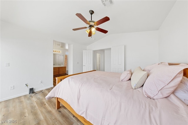 bedroom featuring lofted ceiling, connected bathroom, ceiling fan, and light hardwood / wood-style flooring