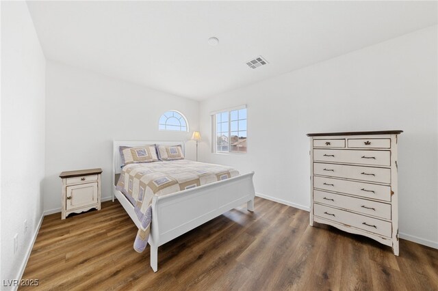 bedroom with dark wood-type flooring