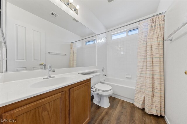 full bathroom featuring shower / tub combo, vanity, hardwood / wood-style flooring, and toilet