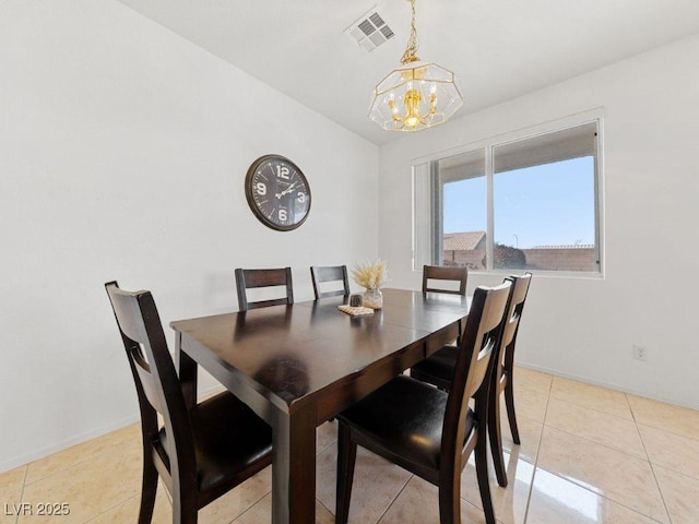 dining room featuring light tile patterned floors, vaulted ceiling, and a chandelier