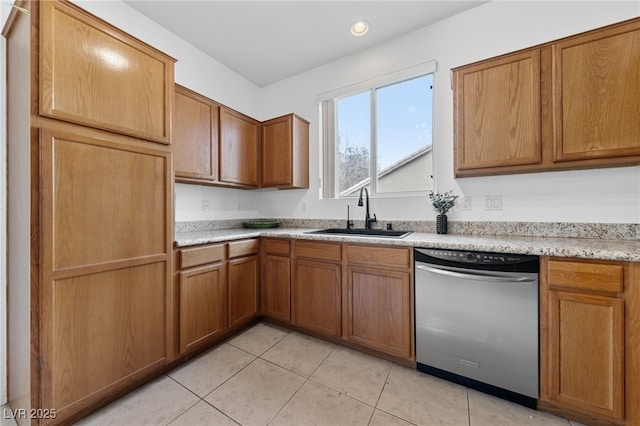 kitchen with sink, stainless steel dishwasher, and light tile patterned flooring