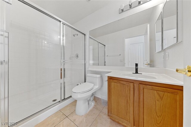 bathroom with tile patterned flooring, vanity, a shower with door, and toilet