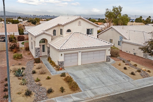 view of front of house featuring a garage and a mountain view