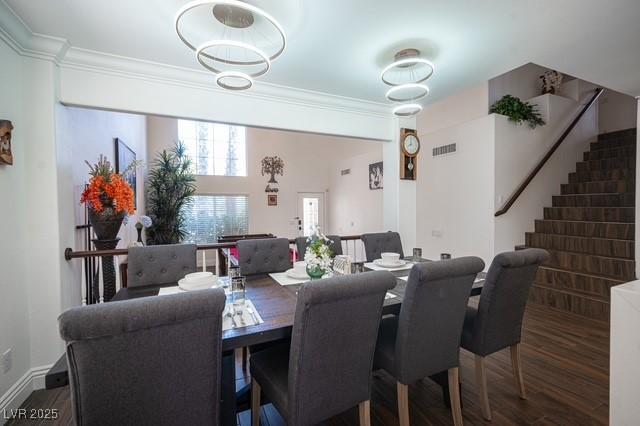 dining room featuring dark hardwood / wood-style flooring and crown molding